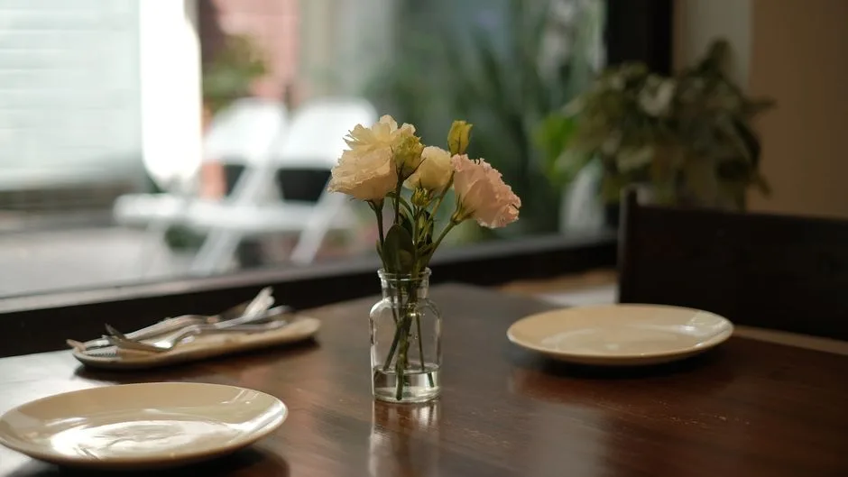 Fresh floral vessels being carried into a restaurant
