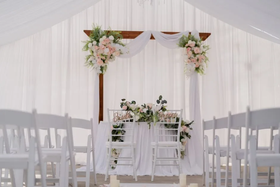 A ceremony arch in May, built with pale spring flowers