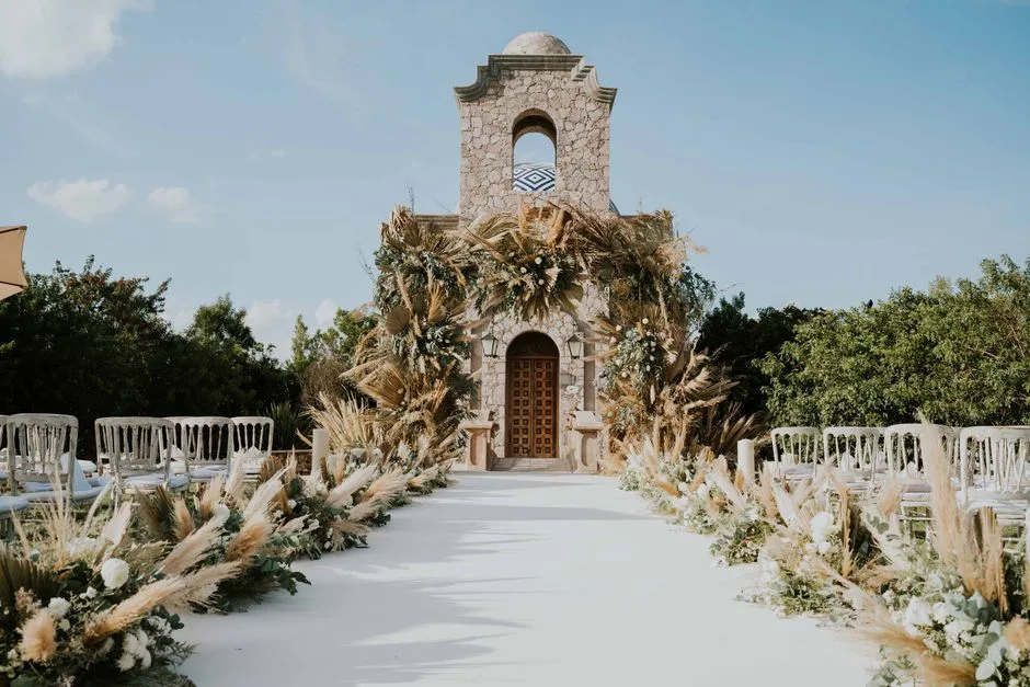 The same ceremony arch in October, built with rich autumn flowers