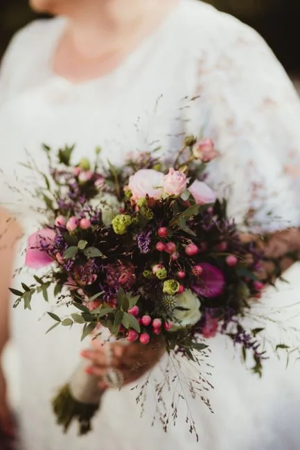 A bridal bouquet of dahlia, garden rose and scabiosa