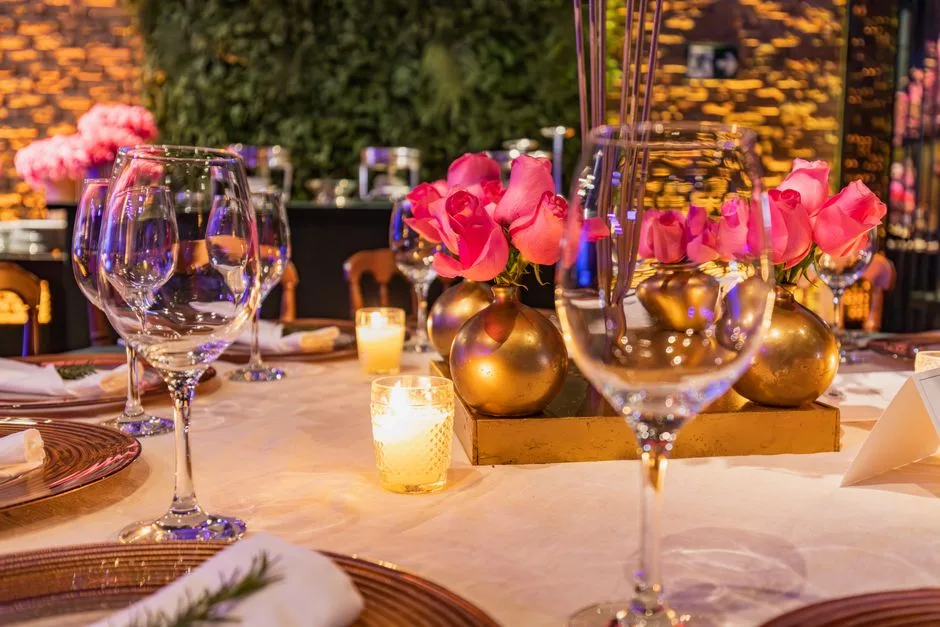 A long dinner table with low floral arrangements