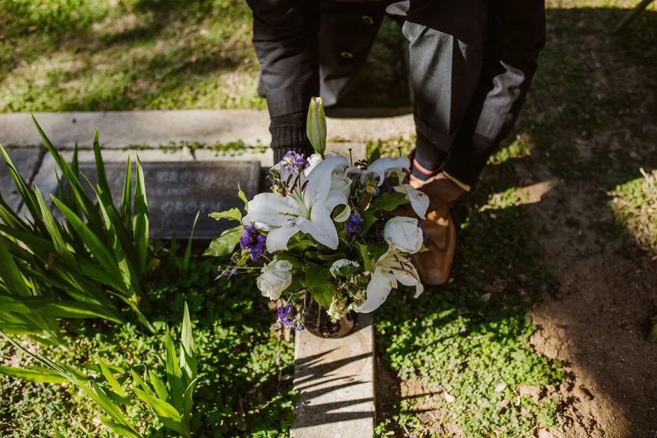 A memorial spray of garden roses and rosemary