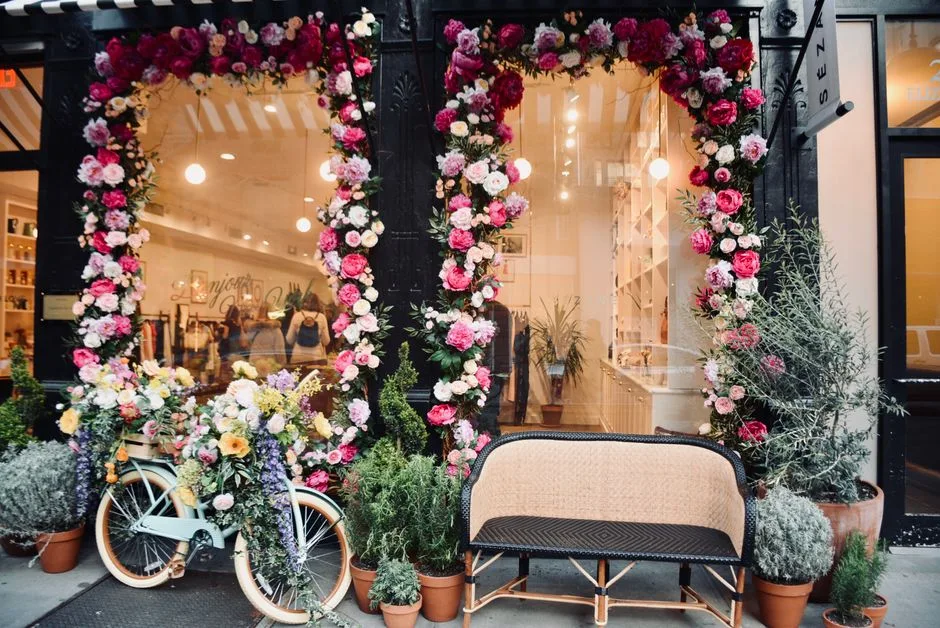 A tall floral statement piece on a plinth