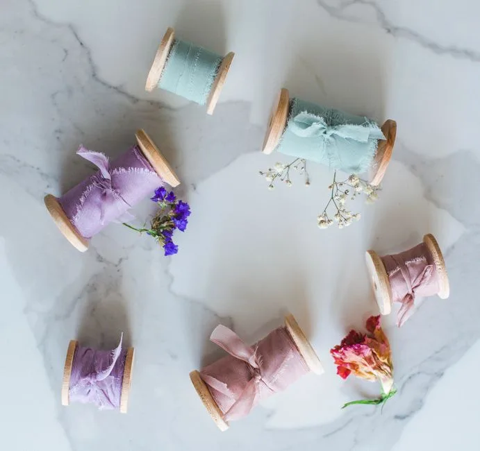 Spools of ribbon hanging on a rail