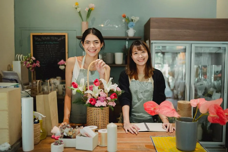 Two florists working at a studio bench